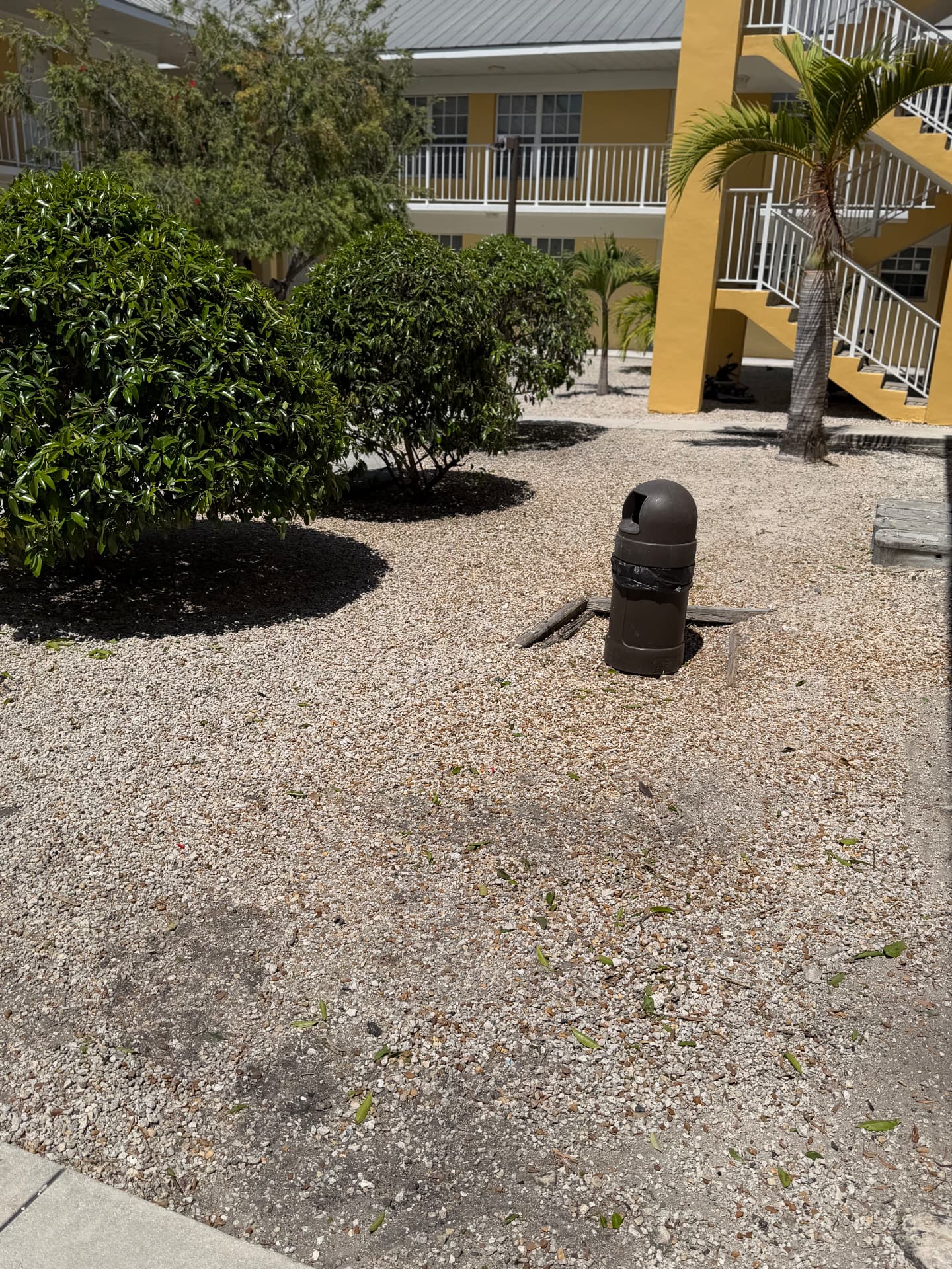Apartment & Commercial Complex Maintenance — Courtyard shrub beds and gravel areas kept clean